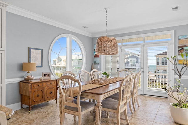 dining space with light tile patterned floors and crown molding