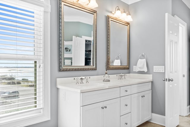 bathroom with dual vanity and ornamental molding