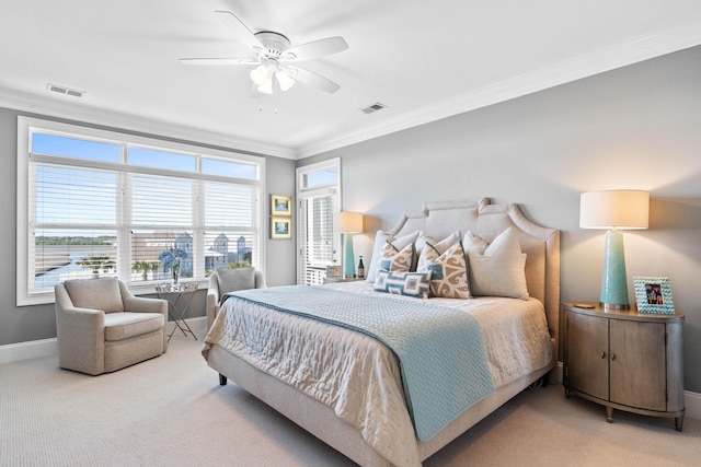 bedroom with ceiling fan, ornamental molding, and light carpet