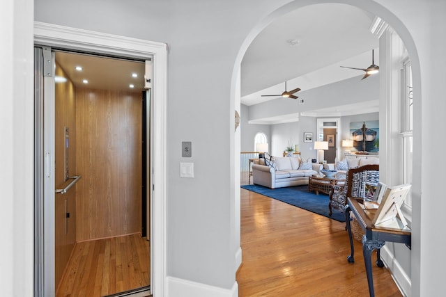 hallway featuring elevator and hardwood / wood-style flooring