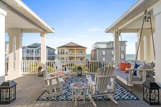 wooden deck with outdoor lounge area and a water view