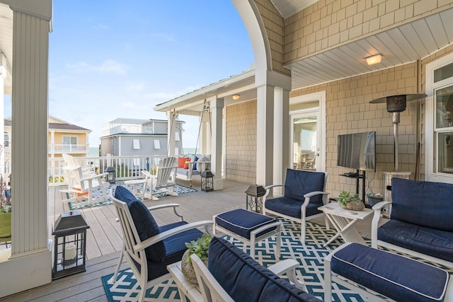 wooden terrace featuring an outdoor living space