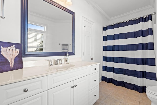 bathroom with tile patterned floors, ornamental molding, vanity, and toilet