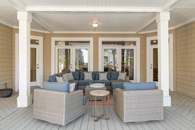 wooden deck with an outdoor hangout area and french doors