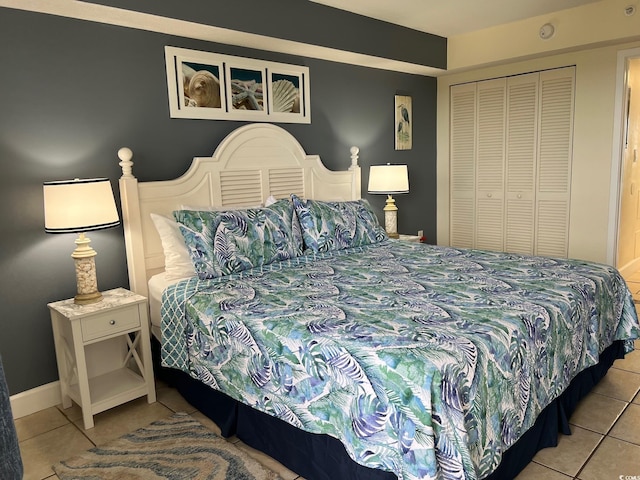 tiled bedroom with a closet