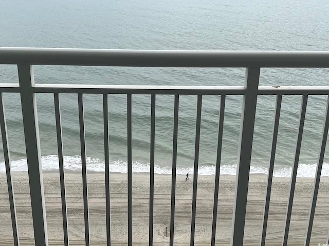 balcony featuring a water view and a beach view