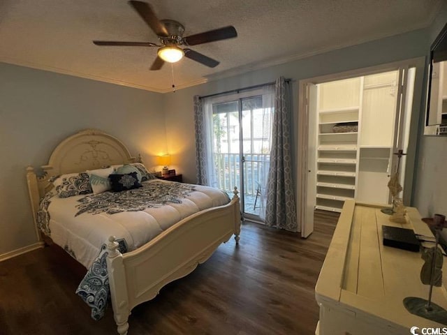 bedroom with dark hardwood / wood-style flooring, ceiling fan, a walk in closet, access to outside, and ornamental molding