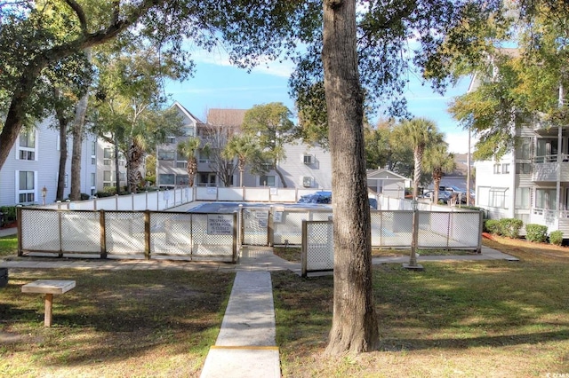 view of pool with a yard