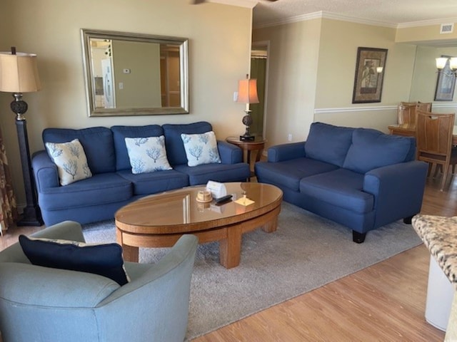 living room featuring crown molding and wood-type flooring