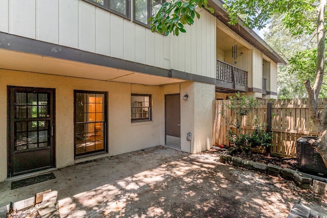 property entrance with a balcony and a patio