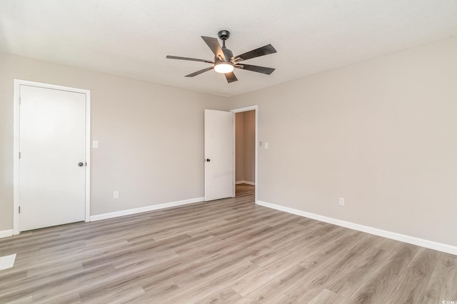 spare room featuring a textured ceiling, light hardwood / wood-style flooring, and ceiling fan