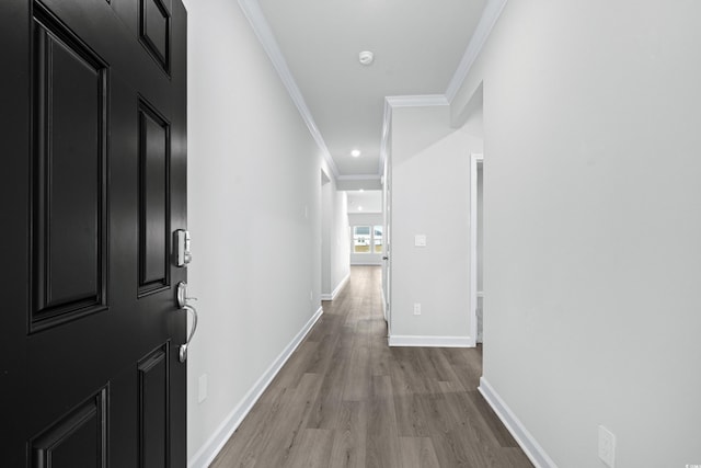 hall featuring light hardwood / wood-style flooring and ornamental molding