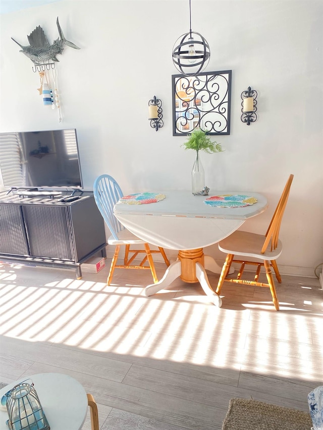 dining space with hardwood / wood-style floors