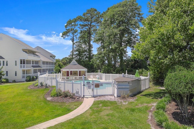 view of pool with a yard