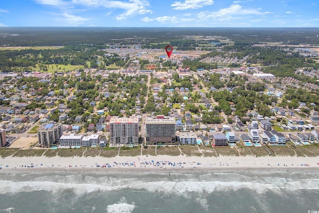 birds eye view of property with a water view and a view of the beach