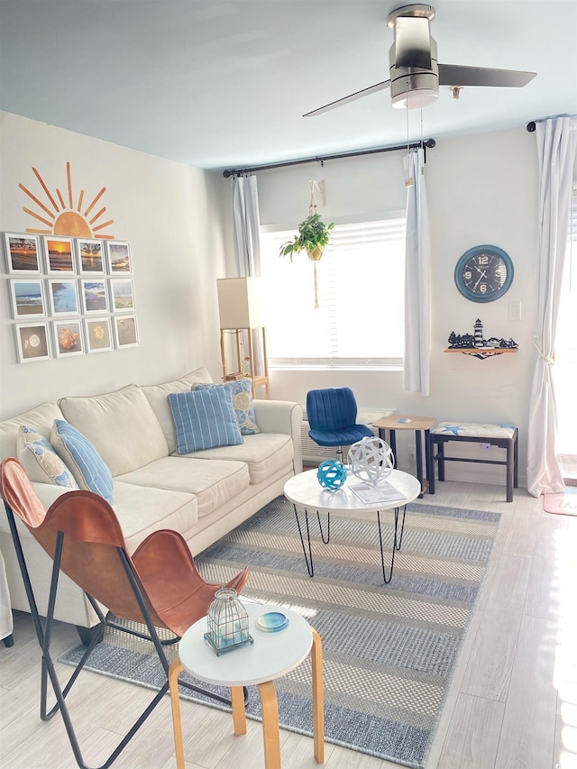 living room with ceiling fan and light wood-type flooring