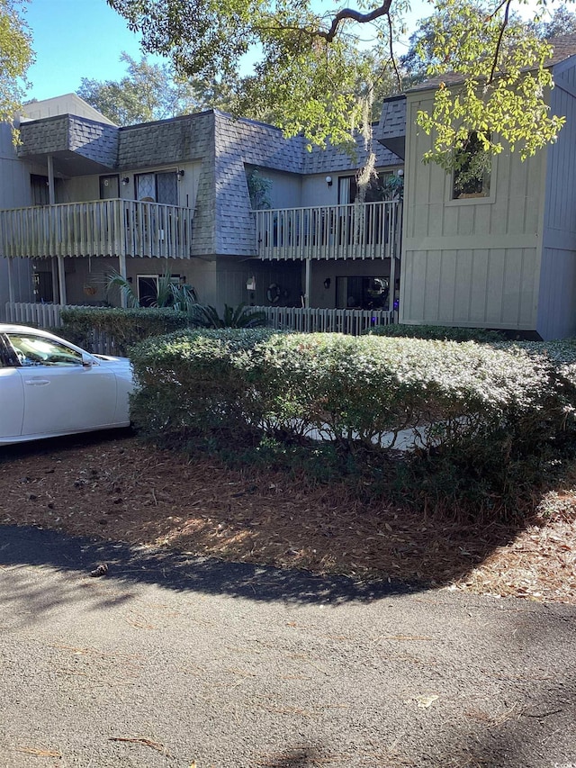 118 Salt Marsh Cir Unit 25B, Pawleys Island, SC 29585 - exterior space featuring a shingled roof, mansard roof, and a balcony