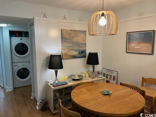 118 Salt Marsh Cir Unit 25B, Pawleys Island, SC 29585 - dining space with stacked washer / dryer and wood finished floors