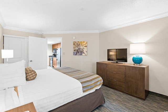 bedroom with ornamental molding and freestanding refrigerator