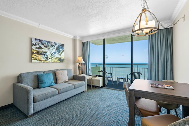 carpeted living area featuring a water view, expansive windows, a textured ceiling, crown molding, and a chandelier