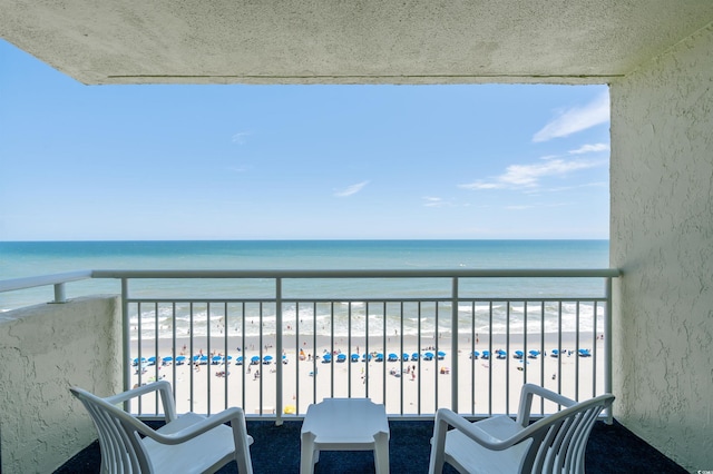 balcony with a beach view and a water view