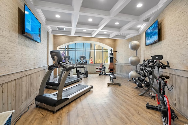 workout room with visible vents, coffered ceiling, a wainscoted wall, wood finished floors, and recessed lighting