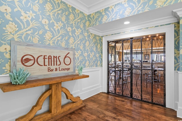 entryway with wood-type flooring and ornamental molding