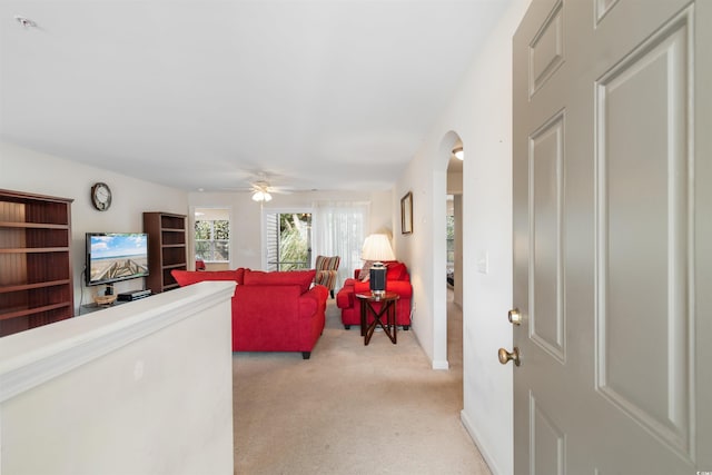 carpeted living room featuring ceiling fan