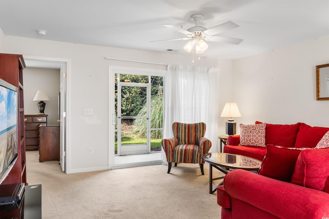 carpeted living room featuring ceiling fan