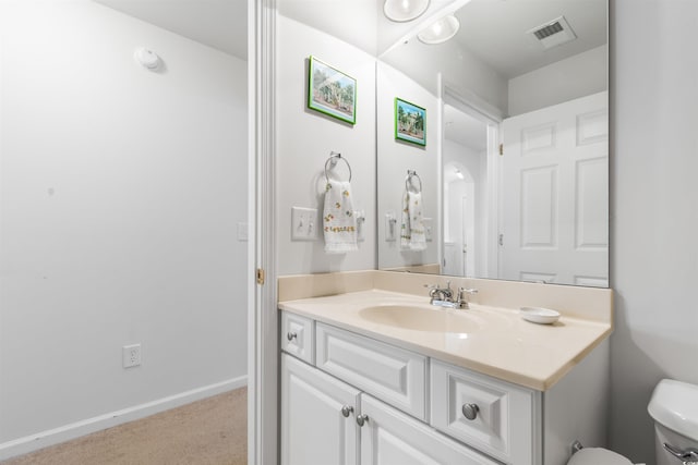 bathroom with vanity and toilet