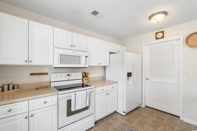 kitchen featuring white appliances and white cabinetry