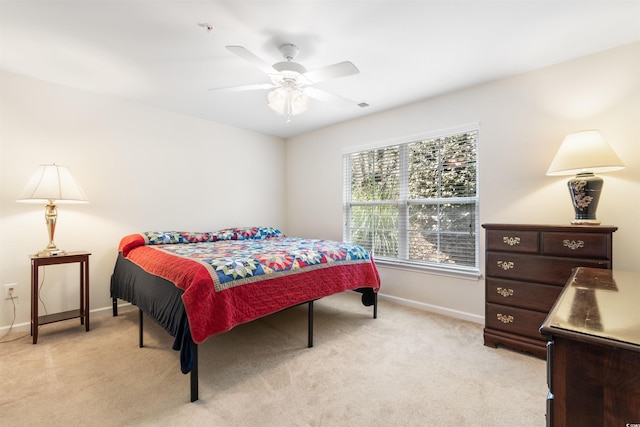 bedroom featuring light carpet and ceiling fan