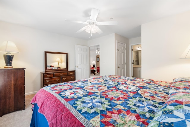 carpeted bedroom with connected bathroom and ceiling fan