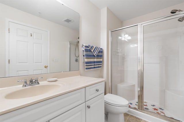 bathroom featuring tile patterned flooring, an enclosed shower, vanity, and toilet