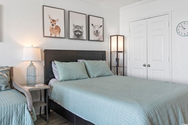 bedroom with a closet, crown molding, and wood finished floors