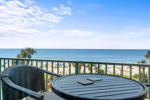 balcony featuring a water view and a view of the beach