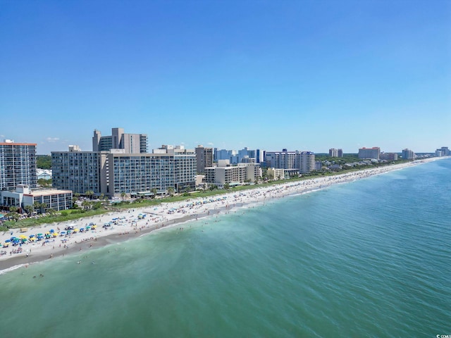 aerial view with a water view, a view of city, and a beach view