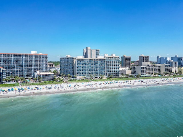 bird's eye view with a water view, a view of city, and a beach view