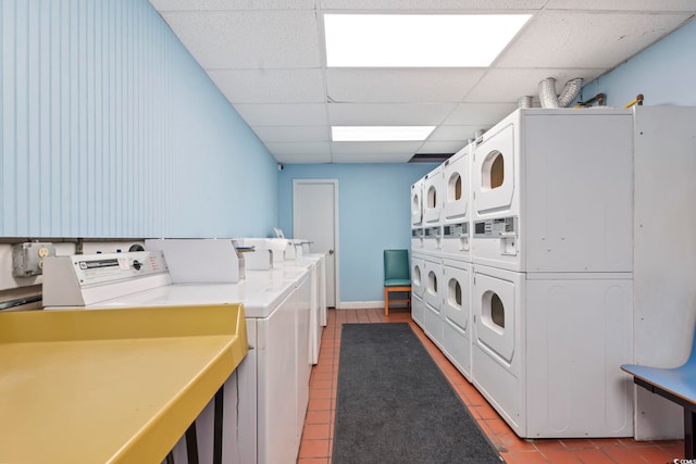 common laundry area featuring washing machine and dryer, stacked washing maching and dryer, and light tile patterned floors