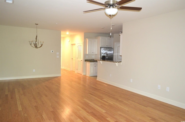 35 Delray Dr Unit 2-C, Murrells Inlet, SC 29576 - unfurnished living room with a chandelier, a ceiling fan, light wood finished floors, and baseboards