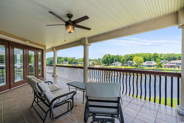 view of patio with ceiling fan, a water view, and french doors