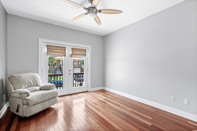 living area with french doors, hardwood / wood-style flooring, and ceiling fan