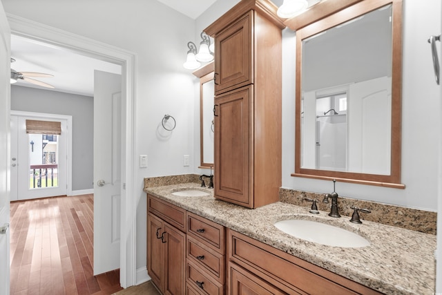 bathroom featuring ceiling fan, hardwood / wood-style floors, and vanity