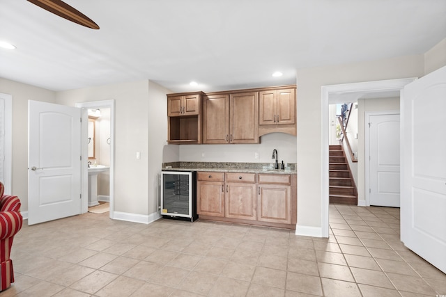 kitchen with wine cooler, sink, and light tile patterned floors