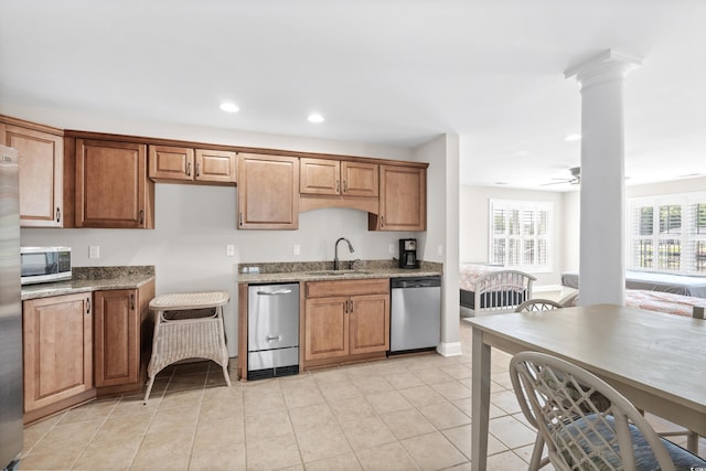 kitchen featuring ceiling fan, sink, light stone countertops, and stainless steel appliances