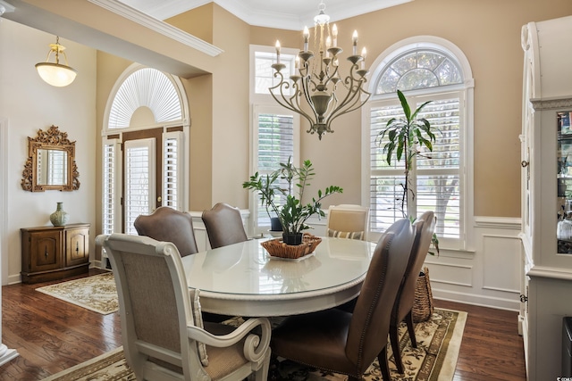 dining area featuring a notable chandelier, a wealth of natural light, dark hardwood / wood-style floors, and ornamental molding