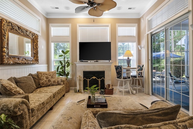 living room featuring ceiling fan, light tile flooring, and crown molding