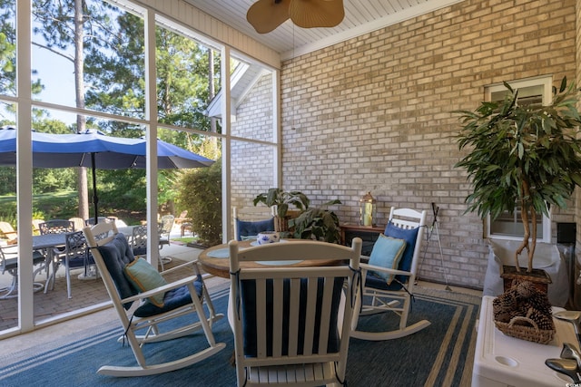 sunroom featuring ceiling fan