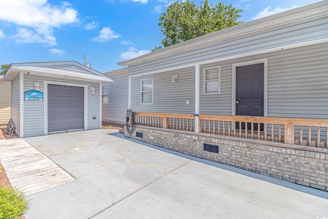 6001-5240 S Kings Hwy, Myrtle Beach, SC 29575 - exterior space featuring covered porch, an outbuilding, and driveway