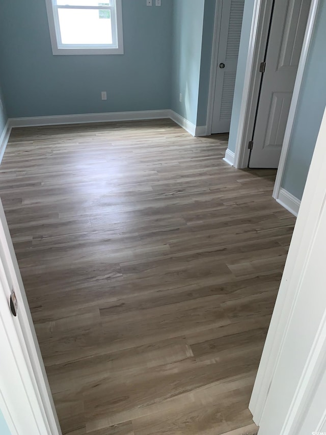 unfurnished room with hardwood / wood-style floors